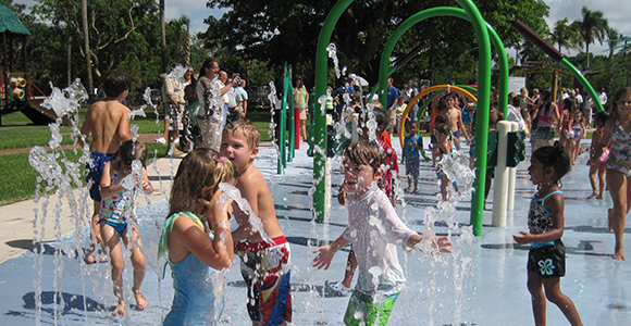 Children playing in water spray